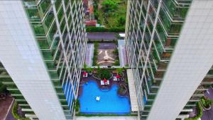 an overhead view of a swimming pool in a building at Lavenderbnb Room 10 at Mataram City Apartment in Yogyakarta