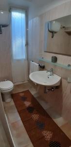 a bathroom with a sink and a toilet at GAIA Accommodation in Alghero