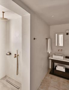 a bathroom with a shower and a sink at Parilio, a Member of Design Hotels in Naousa