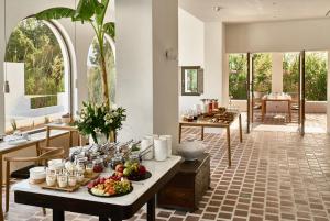 a kitchen with a buffet of food on a table at Parilio, a Member of Design Hotels in Naousa