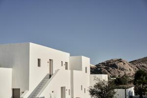 a white building with stairs on the side of it at Parilio, a Member of Design Hotels in Naousa