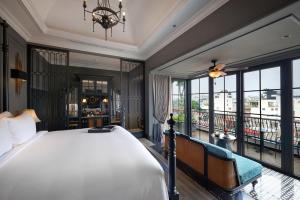 a bedroom with a large bed and a balcony at La Siesta Premium Hang Be in Hanoi