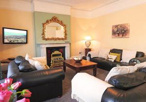 a living room with two couches and a fireplace at Bury Villa - 7 bedrooms sleeping 18 guests in Gosport