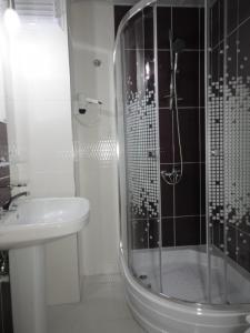 a bathroom with a shower and a toilet and a sink at Rosy Hotel Marmaris in Marmaris
