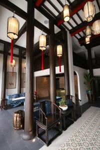 a living room with a table and chairs and lights at Saran Boutique Hotel Thapae in Chiang Mai