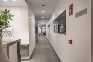 a hallway in a building with white walls at gm hotel in Marchena