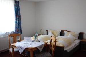 a living room with a couch with a table and a tableablish at Ferienhof Koch in Oedelsheim +8 photos