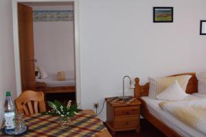 a bedroom with a bed and a table with a lamp at Ferienhof Koch in Oedelsheim