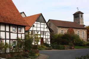 a group of buildings with a church and a street at Ferienhof Koch in Oedelsheim