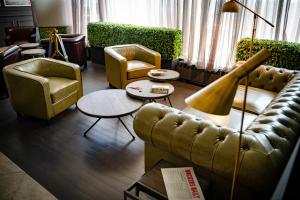 a living room with a couch and chairs and a table at Panorama Hotel - Free EV Charging Station in Varna City