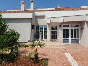 a large white house with a driveway at Romantik Pearl with free EV Ch-Station in Valbandon
