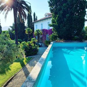 a swimming pool in front of a house at Resort Villa San Luca CITR8031 in Imperia
