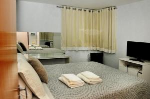 Tempat tidur dalam kamar di Elza's Appartament