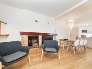 a living room with a table and chairs and a fireplace at Holiday Home Paris by Interhome in Calonge