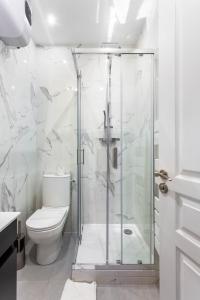 a bathroom with a shower and a toilet at CMG Parc de Bercy - Madagascar in Paris