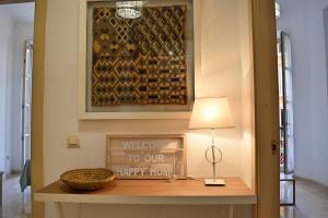a hallway with a table with a lamp and a picture at Apartamento Santos 7 in Málaga +32 photos