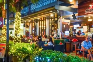 a group of people sitting in a restaurant at night at Villa 3 beds Sukhumvit Asok in Bangkok