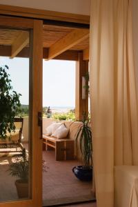 a living room with a couch on a patio at Hotel Aquadulci in Chia
