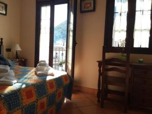 Ένα ή περισσότερα κρεβάτια σε δωμάτιο στο Vivelorural casa Tassone, Grazalema - Cádiz