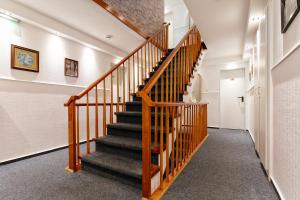 a staircase in a house with wooden railings at Hotel Helgolandia in Helgoland +8 photos