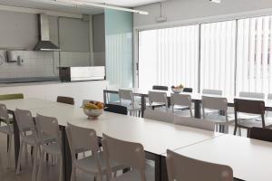 a large room with white tables and chairs at Residència Universitària Sant Joan in Reus