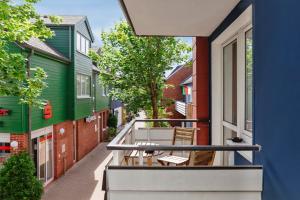 a balcony of a house with chairs on it at Hotel Helgolandia in Helgoland