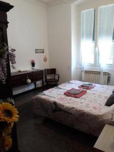 a bedroom with a bed and a table at Nonna Lucia Holidays in Rapallo
