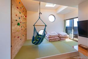 a rock climbing room with a hanging hammock at L-BASE in Matsumoto