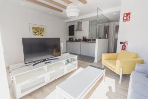 TV a/nebo společenská místnost v ubytování Slow León Apartamentos Turísticos