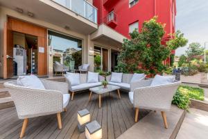 a patio with wicker chairs and a table at Residence Altomare in Riccione