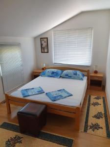 a bedroom with a large bed with blue pillows at Apartman Blagaj in Blagaj