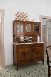 a wooden cabinet with a sink and a mirror at Chez Georges in Parikia