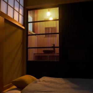 Una cama o camas en una habitación de Kinoya Hostel