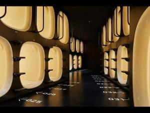 a row of urinals lined up in a restroom at 9h nine hours Nakasukawabata Station in Fukuoka +4 photos