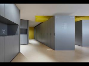 a hallway with a row of lockers in a building at 9h nine hours Nakasukawabata Station in Fukuoka