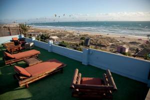 a view of the beach from a balcony with chairs and tables at Arte Vida in Tarifa