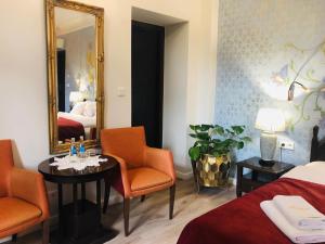a hotel room with two beds and a mirror at Hotel Ester in Kraków
