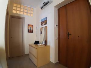 a room with a wooden door and a wooden dresser at A DUE PASSI DAL BLU in Marina di Gioiosa Ionica