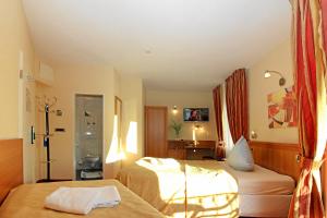 Postel nebo postele na pokoji v ubytování Hotel-Restaurant Axion