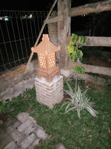 a light with a cross on top of a house at JOGLOPARI GuestHouse bukan untuk pasangan non pasutri in Bantul