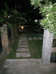 een loopbrug in de tuin 's nachts bij JOGLOPARI GuestHouse bukan untuk pasangan non pasutri in Bantul