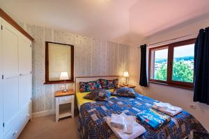 a bedroom with a bed and a window at Mountain View Aparthotel in Bansko +108 photos