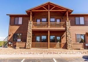 eine große Blockhütte mit seitlicher Terrasse in der Unterkunft Elegant Cottage with Wonderful Views near FH Lake in Show Low