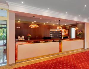 a lobby with a reception desk in a building at Hotel Schweizer Hof Thermal und Vital Resort in Bad Füssing