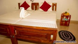 Postel nebo postele na pokoji v ubytování Globetrotter Tourist Inn