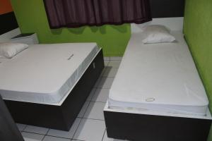 Кровать или кровати в номере Bras Hotel