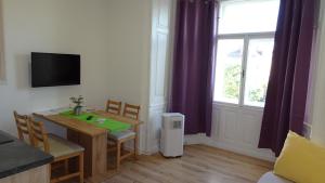 a small dining room with a table and a window at Luna Apartments in Vienna