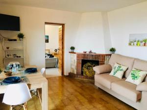 a living room with a couch and a fireplace at CASA PAQUITA ¡¡¡VISTAS ESPECTACULARES!!! in Sant Josep de sa Talaia