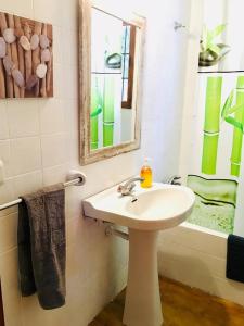 a bathroom with a sink and a mirror and a tub at CASA PAQUITA ¡¡¡VISTAS ESPECTACULARES!!! in Sant Josep de sa Talaia