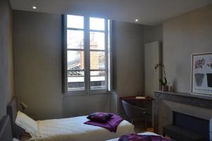 Burdigala Homes - Appart rue Ausone tesisinde bir odada yatak veya yataklar
